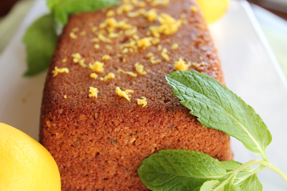 closeup of loaf with fresh mint leaves and lemon zest on top