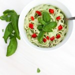 vegan basil cream sauce over pasta with tomatoes