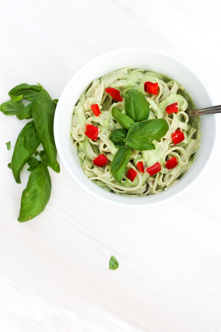 vegan basil cream sauce over pasta with tomatoes