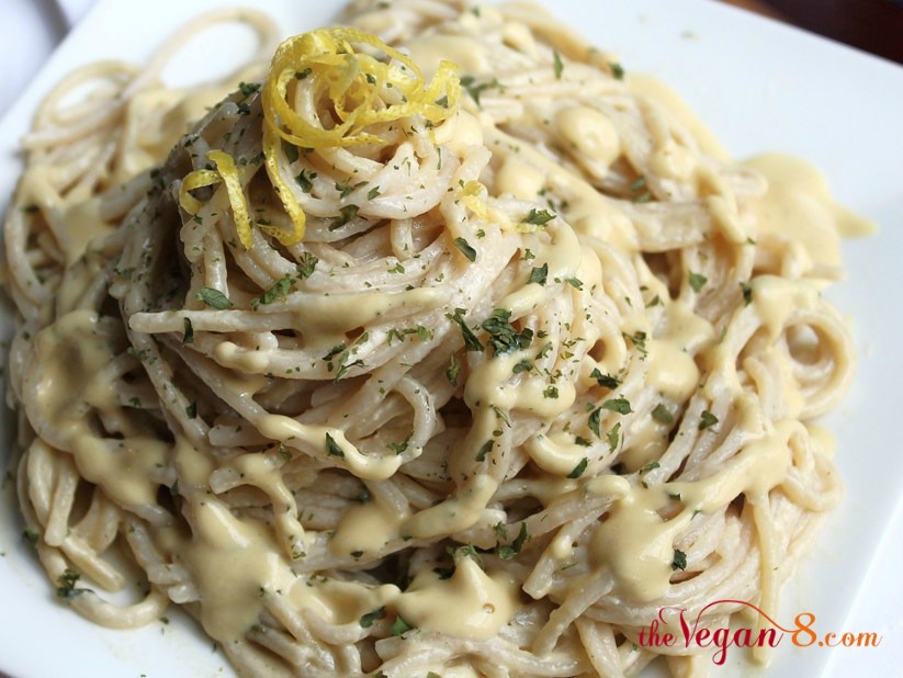 Vegan garlic alfredo sauce and pasta on white plate