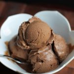 several scoops of vegan mocha chocolate ice cream in white bowl