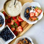 bowls of granola with fresh fruit and yogurt