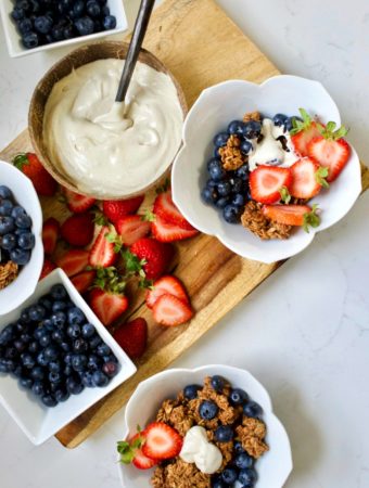 bowls of granola with fresh fruit and yogurt