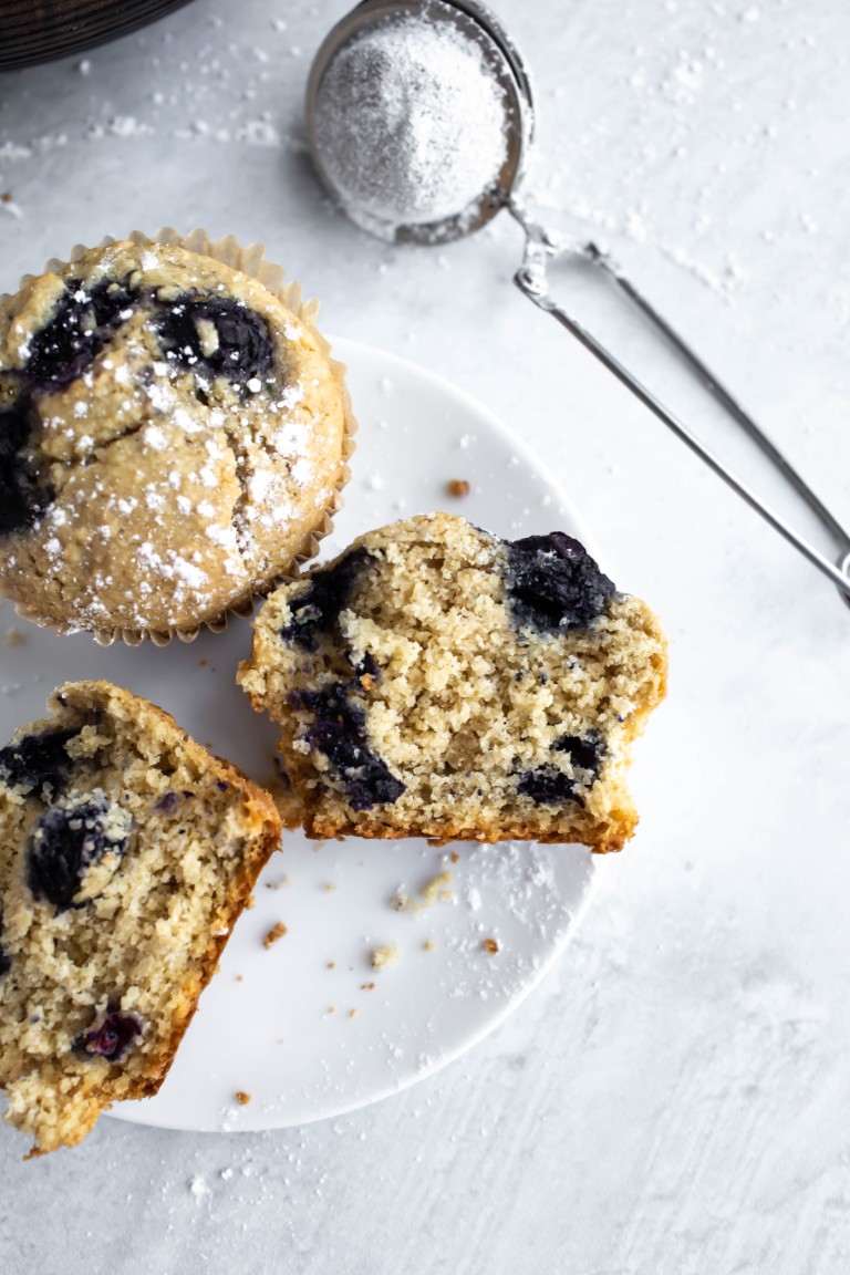 closeup of inside of muffin showing fluffy texture on white plate