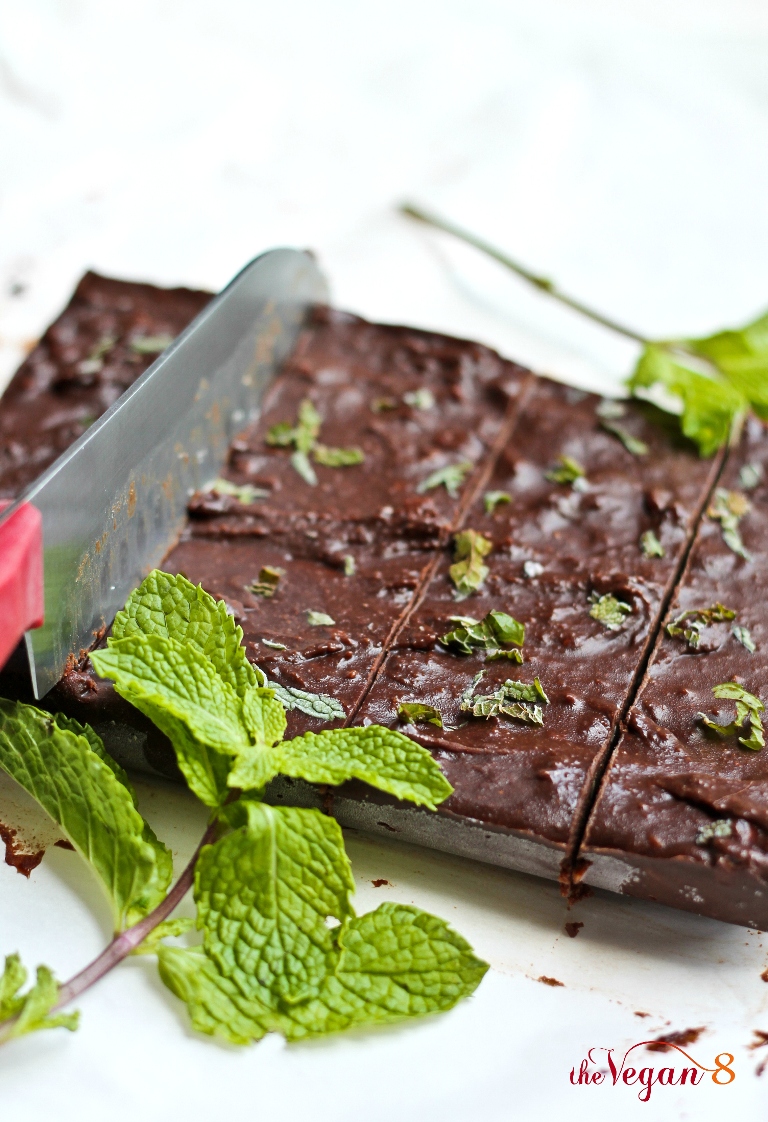 knife slicing through vegan mint chocolate fudge on parchment paper