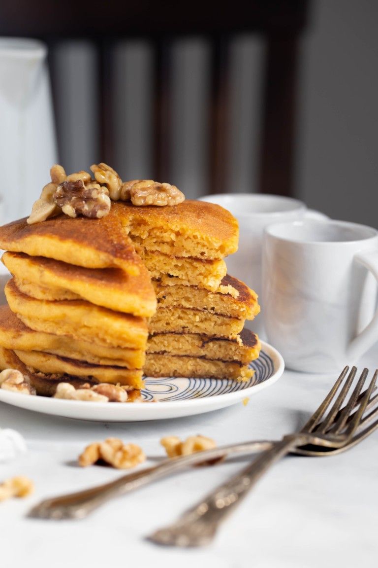 plate of stacked pancakes cut open to show fluffy inside