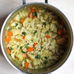 overhead shot of large pot of vegan chicken noodle soup
