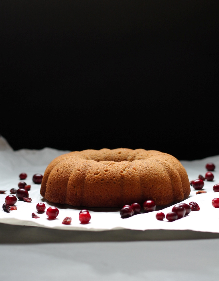 Vegan cranberry bundt cake on white parchment paper