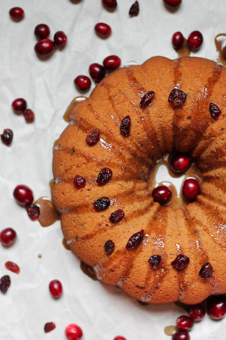 Overhead view of cranberry bundt cake with scattered cranberries