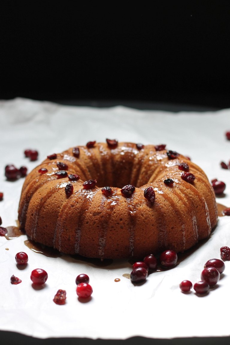 Vegan cranberry bundt cake with maple glaze and cranberries