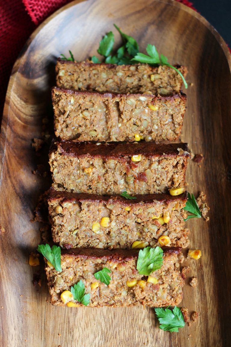 Sliced vegan barbecue lentil loaf on wood platter
