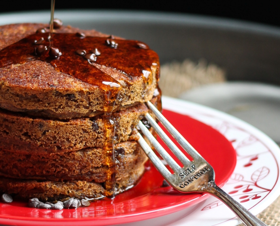 stack of vegan gluten free pumpkin pancakes on red plate with fork