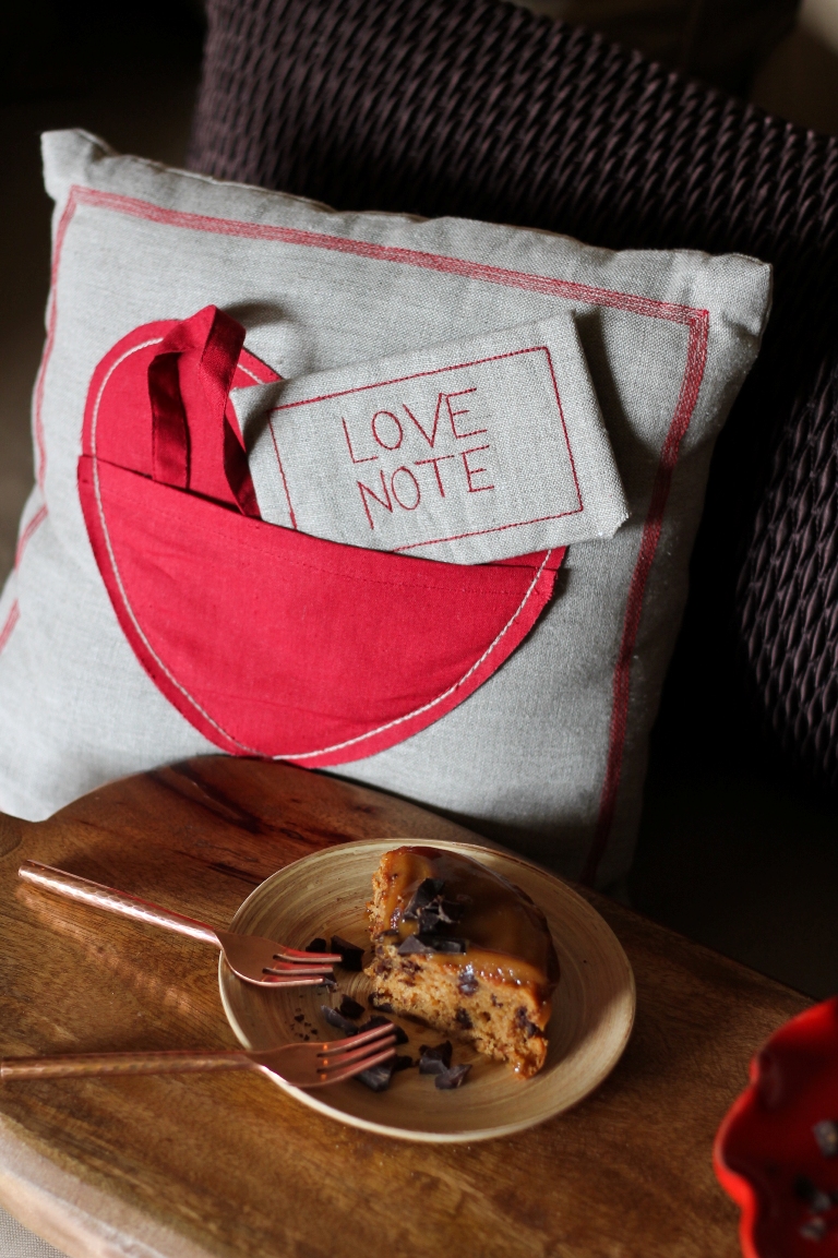 Slice of vegan peanut butter chocolate chip cake with 2 forks
