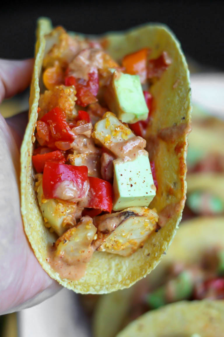 hand holding taco closeup