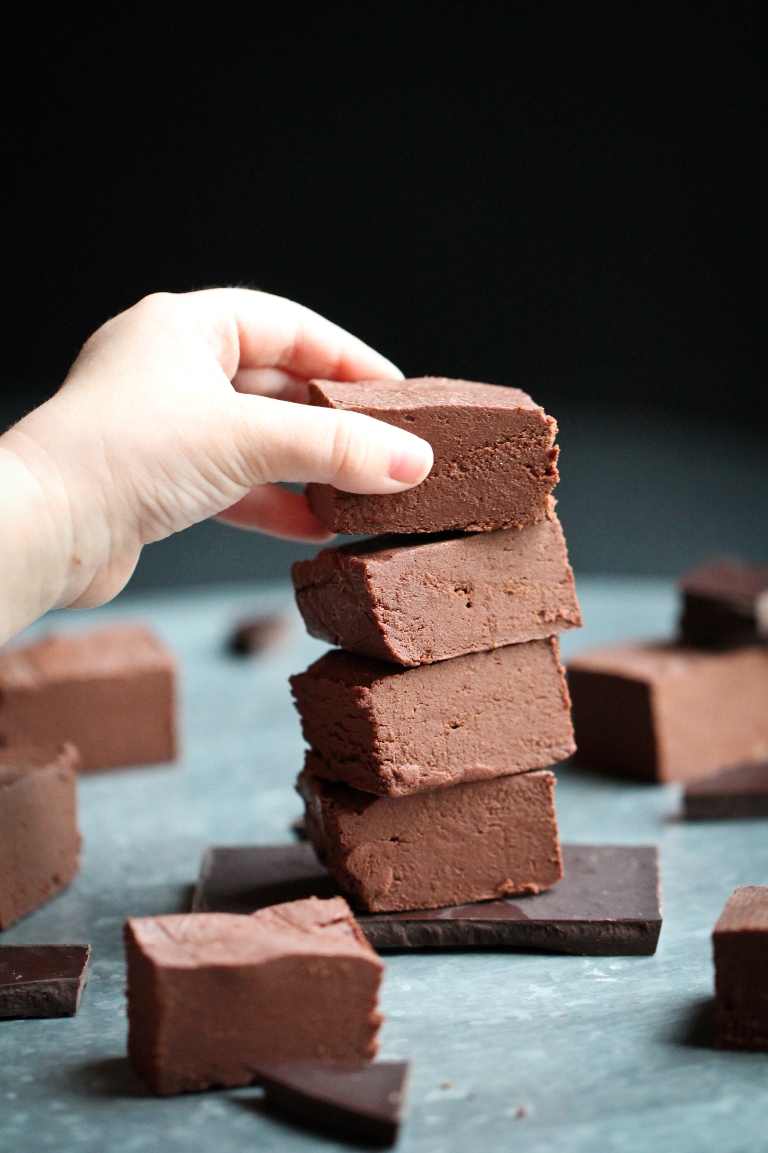 little hand grabbing a piece of fudge from stack