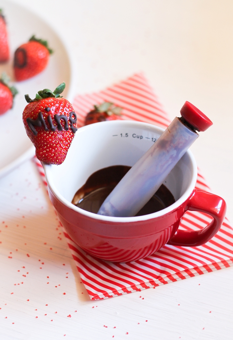 Chocolate writing pen in red cup filled with chocolate