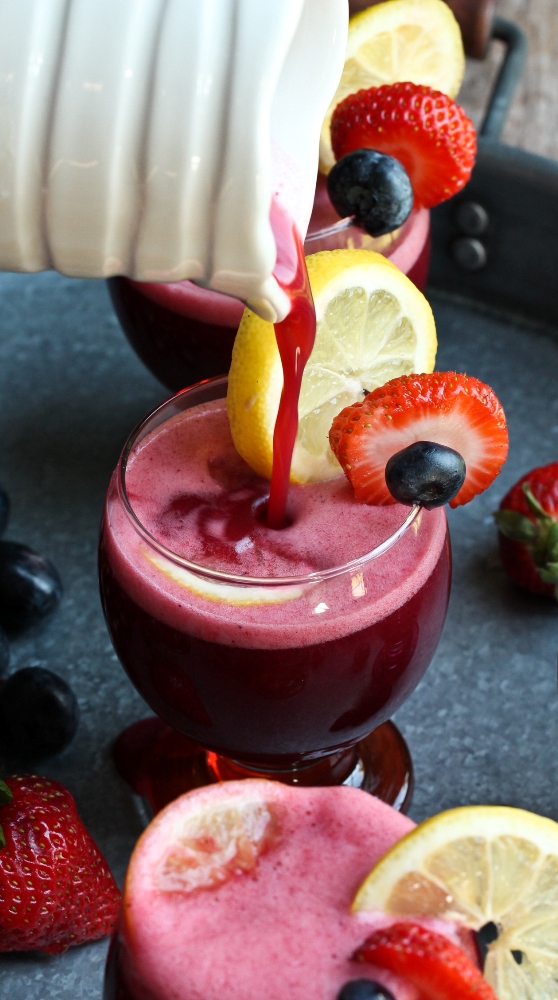 pitcher pouring fruit punch into glass