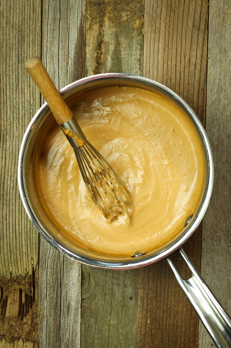 Vegan Mexican cheese sauce with whisk in a pot