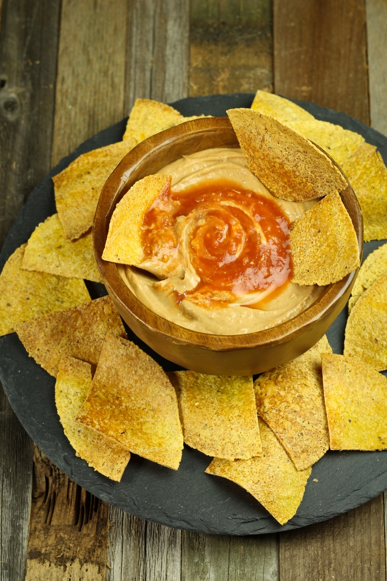 Vegan Mexican cheese sauce with salsa in wooden bowl