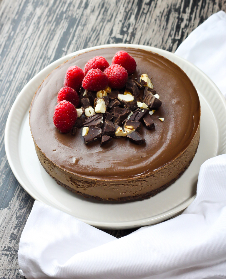 Full vegan chocolate cheesecake with berries and chopped chocolate