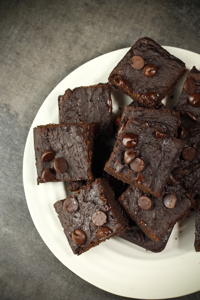 White plate of a stack of vegan fudgy brownies