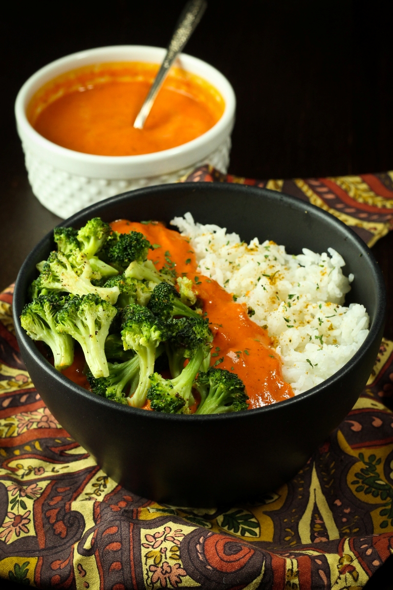 vegan red pepper curry bowl with sauce and broccoli