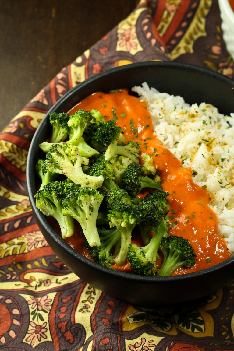 bowl of vegan red pepper curry with rice and broccoli