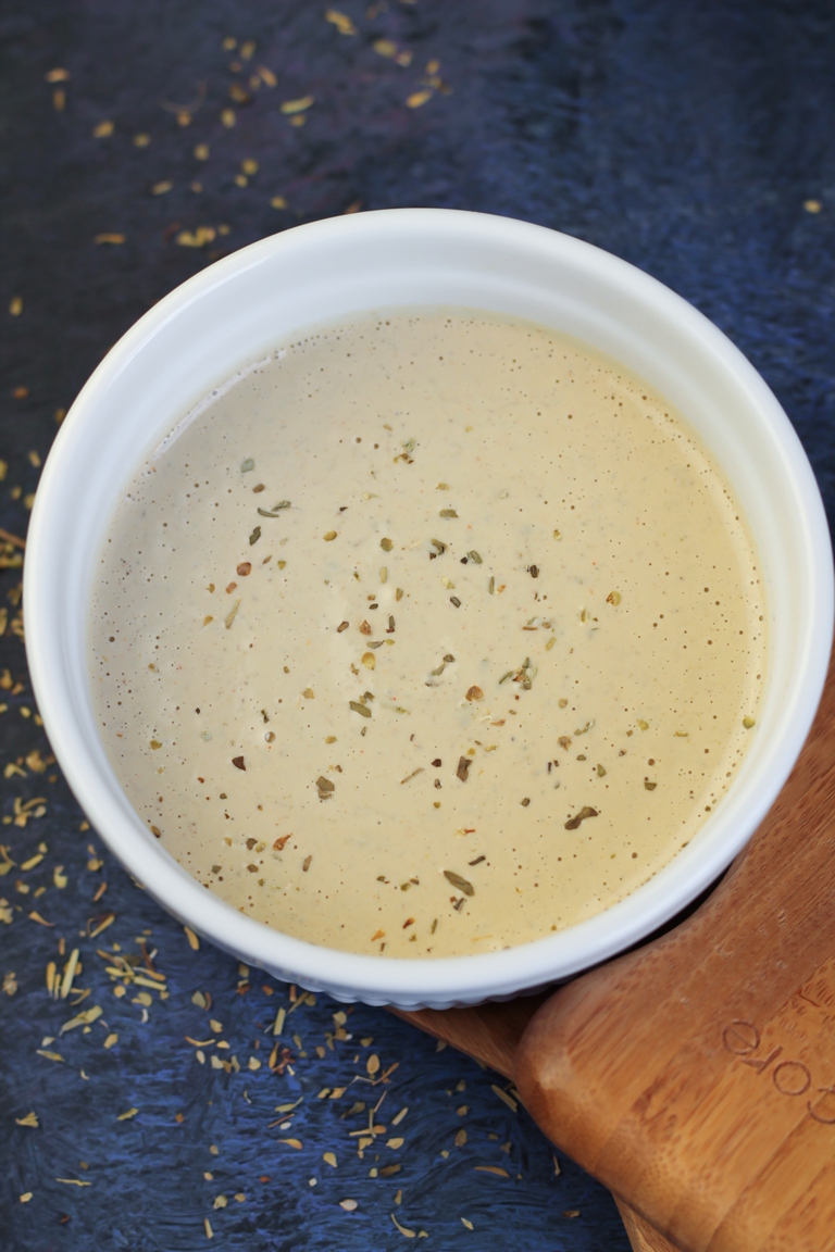 Small white bowl with vegan creamy Italian dressing.