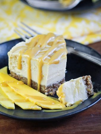 slice of vegan mango caramel cheesecake on plate