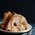 slice of vegan cranberry cake on white plate