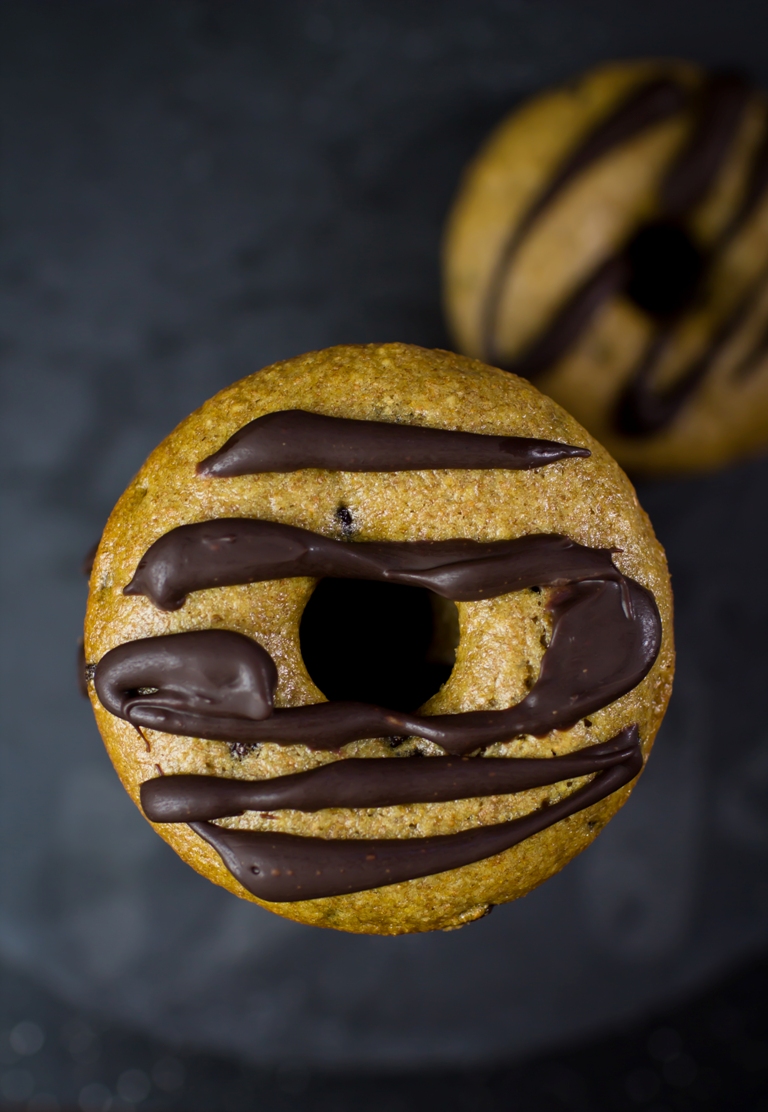 Vegan baked chocolate chip donut with ganache drizzle