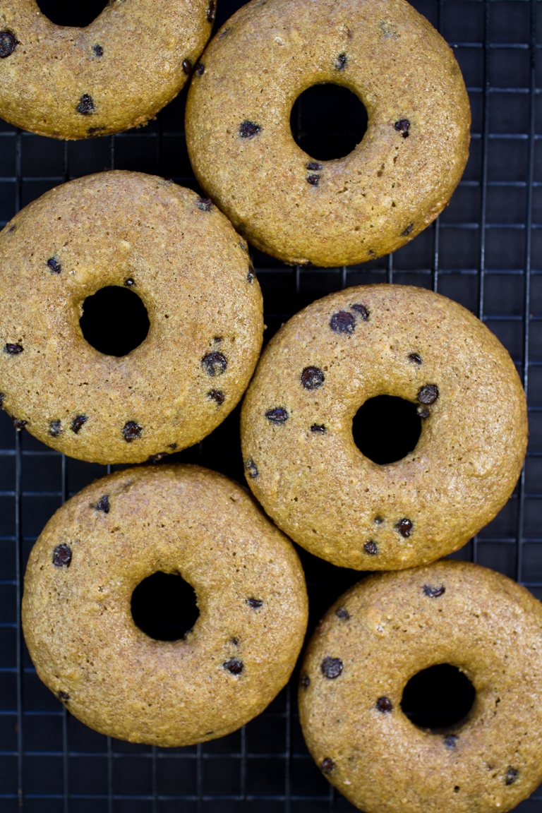 Baked vegan chocolate chip donuts on cooling rack