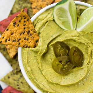 Avocado hummus in bowl with jalapenos
