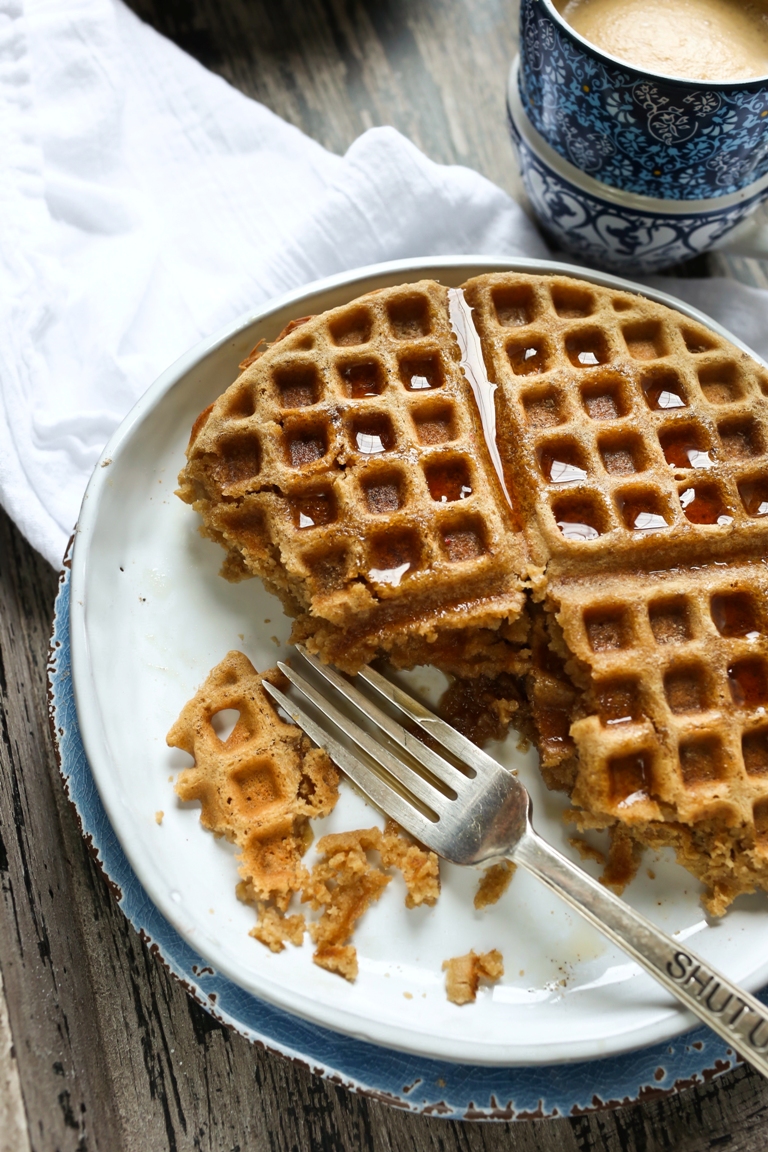 Half eaten plate of vegan chai waffles with fork
