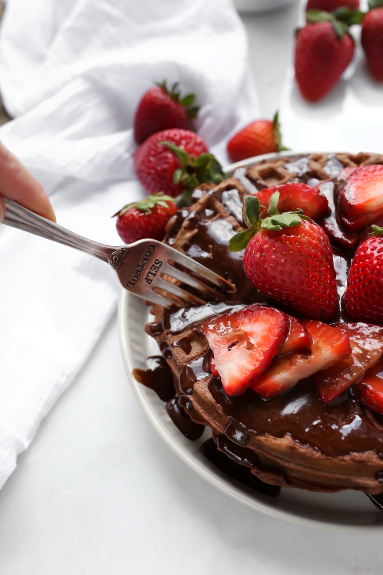 Fork cutting through a stack of vegan chocolate waffles