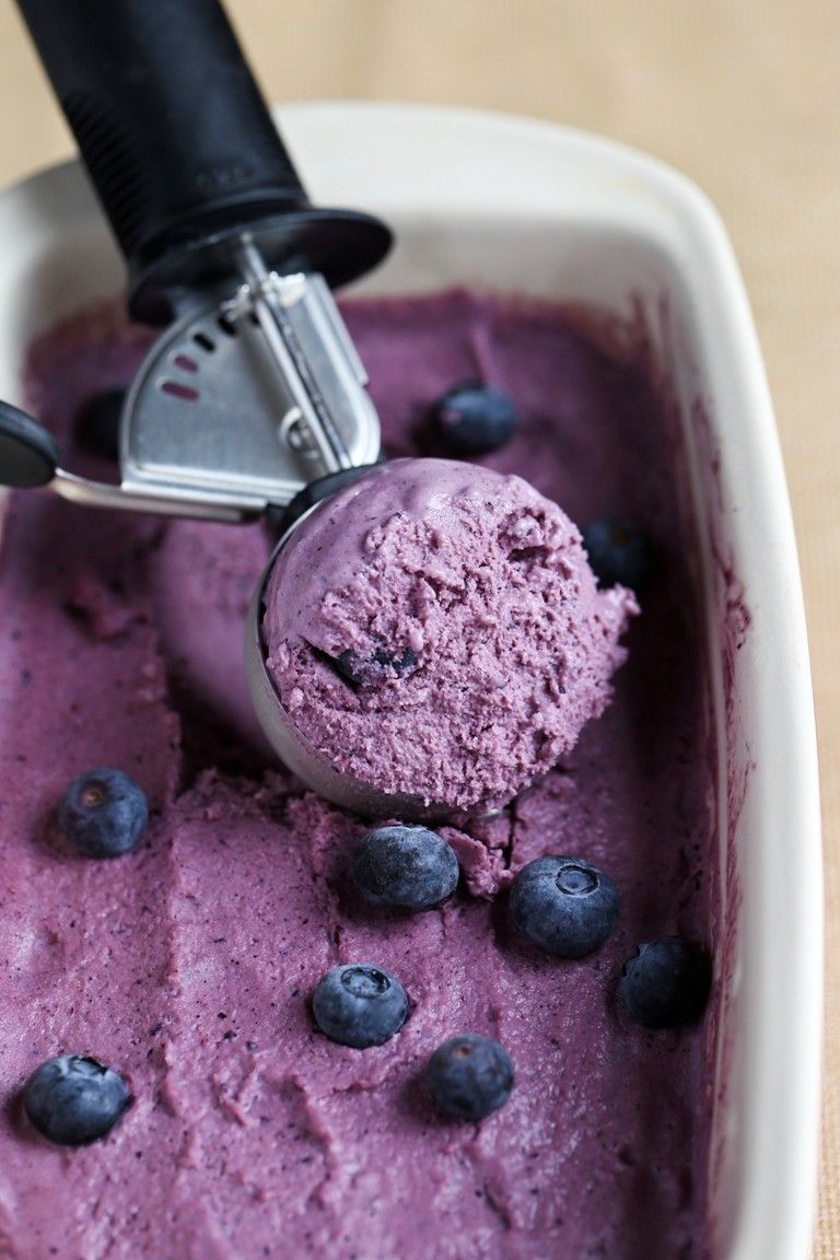 ice cream scoop in dish of blueberry ice cream