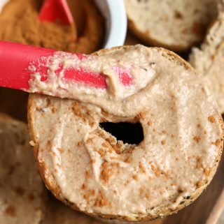 Spreading Vegan Apple Cinnamon Cream Cheese on bagel
