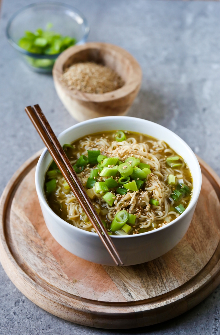 Bowl of vegan ramen noodle soup with green onions on top