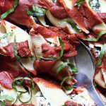 Vegan stuffed ricotta shells with tomato sauce.