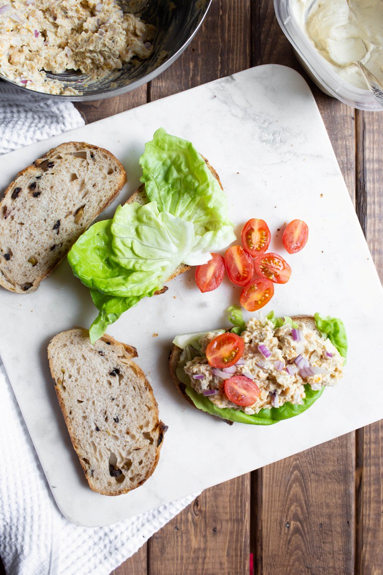 Slices of bread with tomatoes and vegan Caesar chickpeas