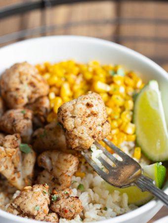 closeup view of fork holiding a piece of cauliflower