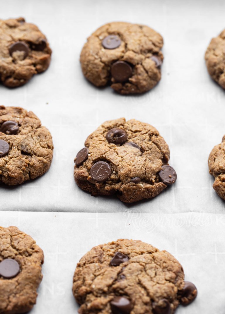 Just baked vegan chocolate chip cookies on parchment paper