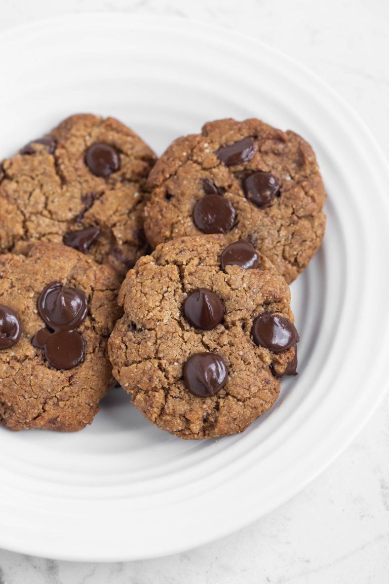 White plate of several grain-free chocolate chip cookies