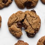 Grain-free chocolate chip cookie broken with melted chocolate