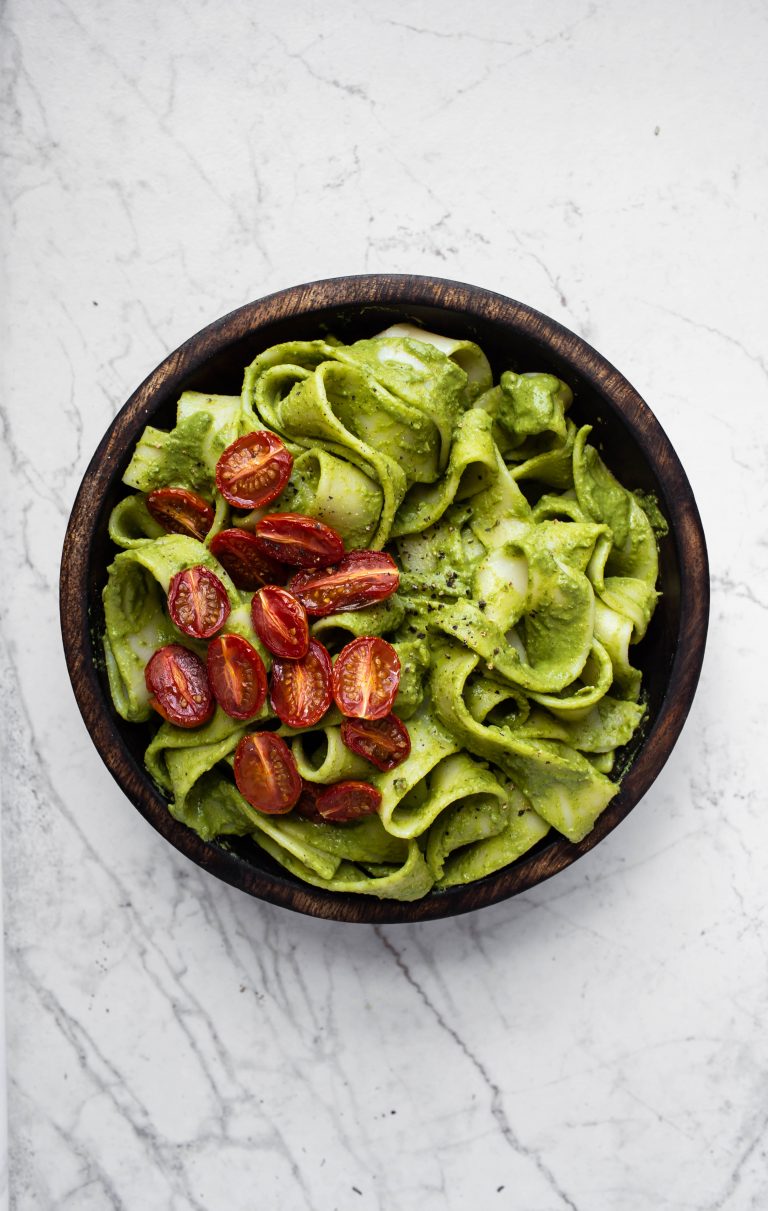 roasted cherry tomatoes on top of chimichurri noodles