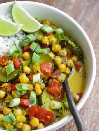 closeup view of yellow curry with spoon in bowl
