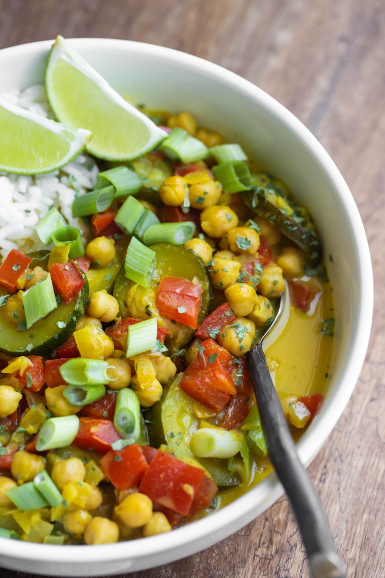closeup view of yellow curry with spoon in bowl