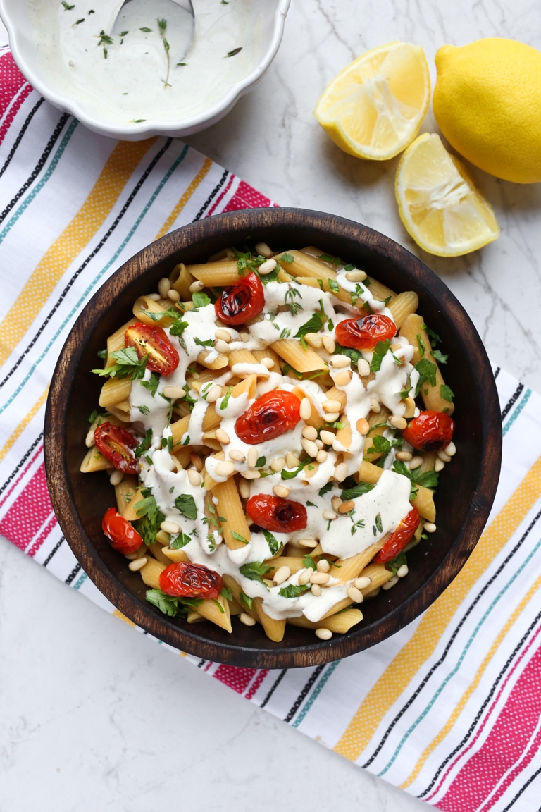 bowl of lemon sauce over pasta with side bowl of lemon cream sauce