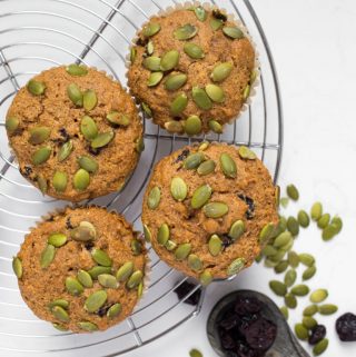 4 vegan pumpkin muffins with pumpkin seeds and cherries