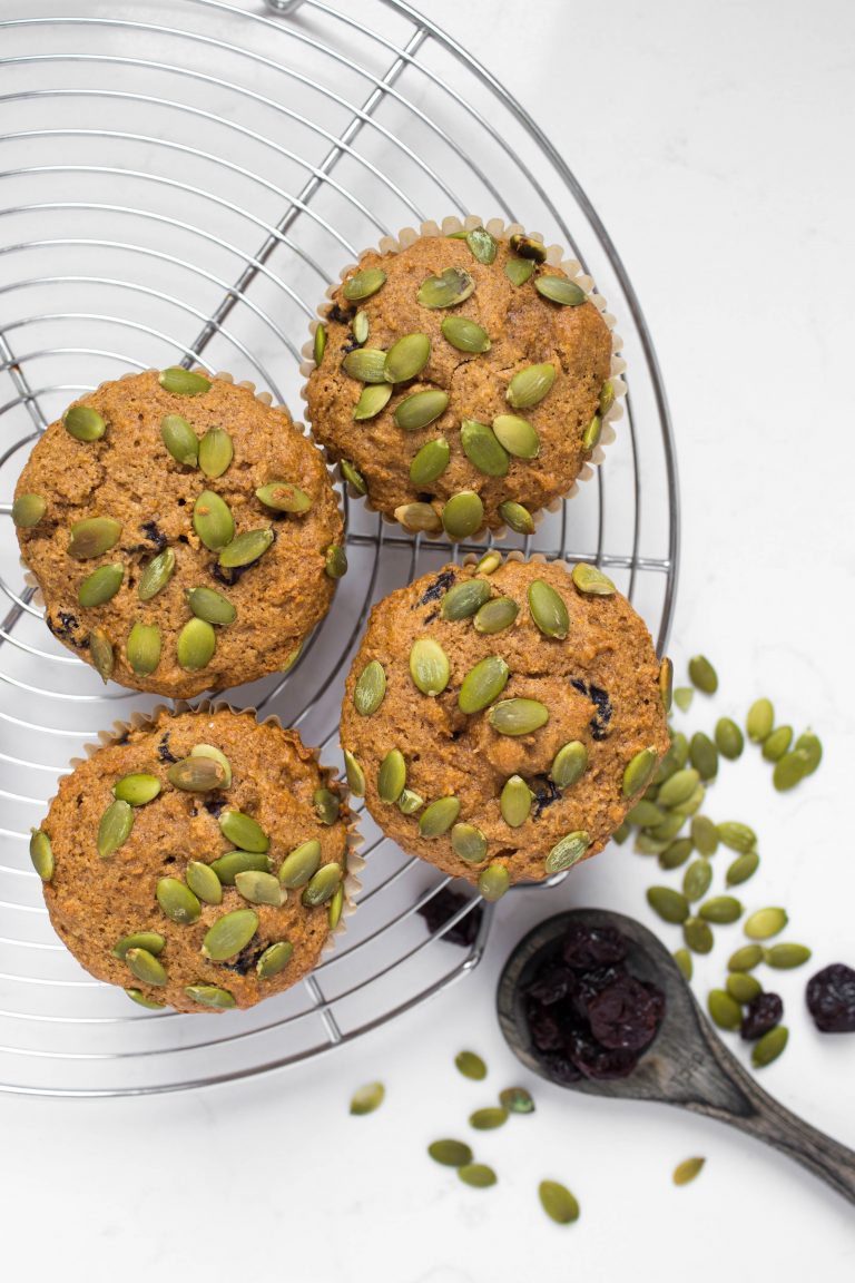 4 vegan pumpkin muffins with pumpkin seeds and cherries